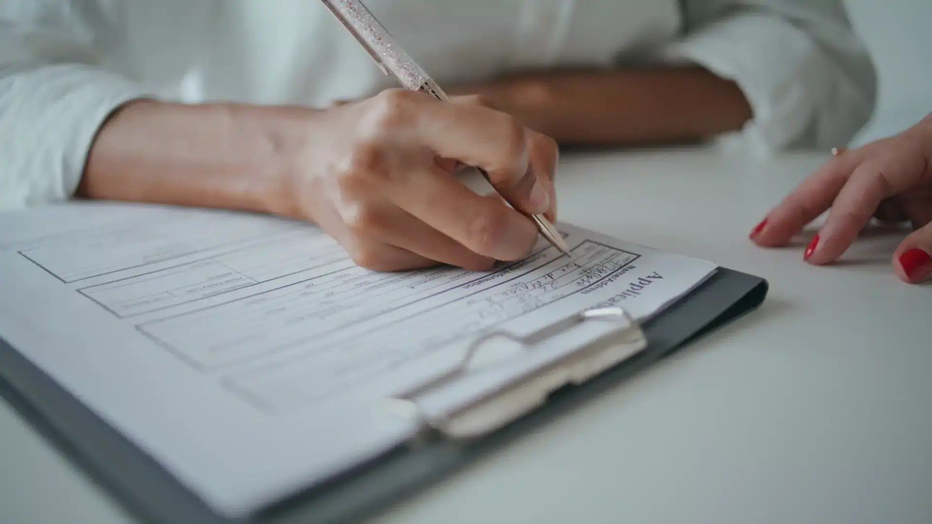 Hands signing a consent form on a clipboard at an aesthetic practice, illustrating the written authorization HIPAA requires before using a patient in marketing.