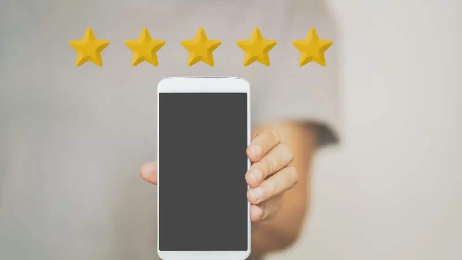 A hand holding a phone showing a five-star review for a med spa, illustrating how patient reviews act as a local SEO ranking signal.