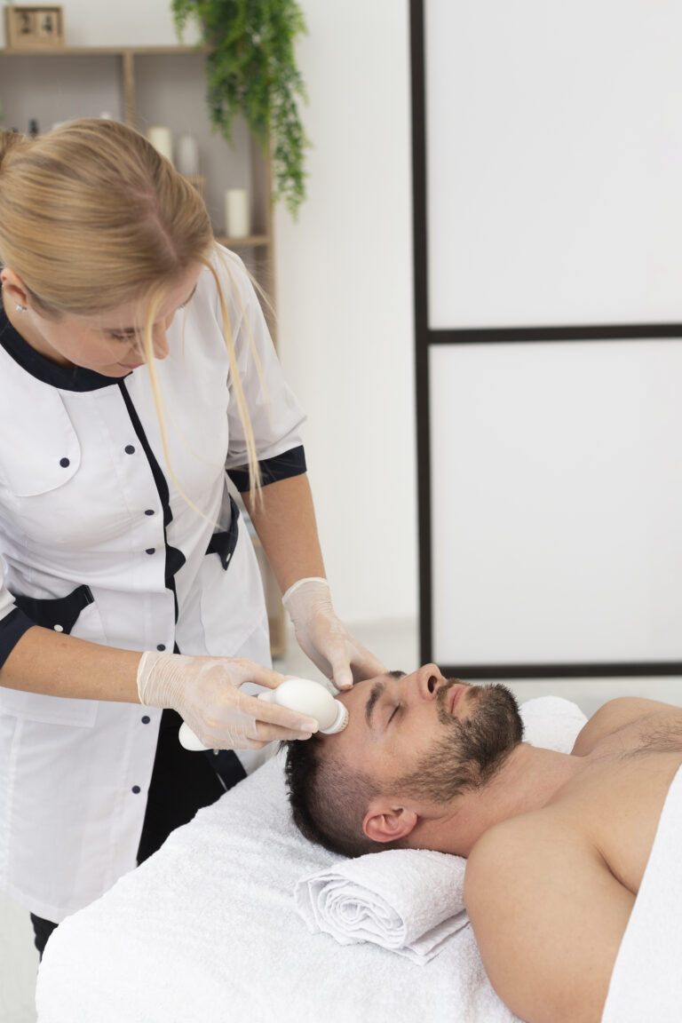 Aesthetician performing facial treatment on a male patient — men's aesthetic SEO services help clinics attract more male patients through Google search