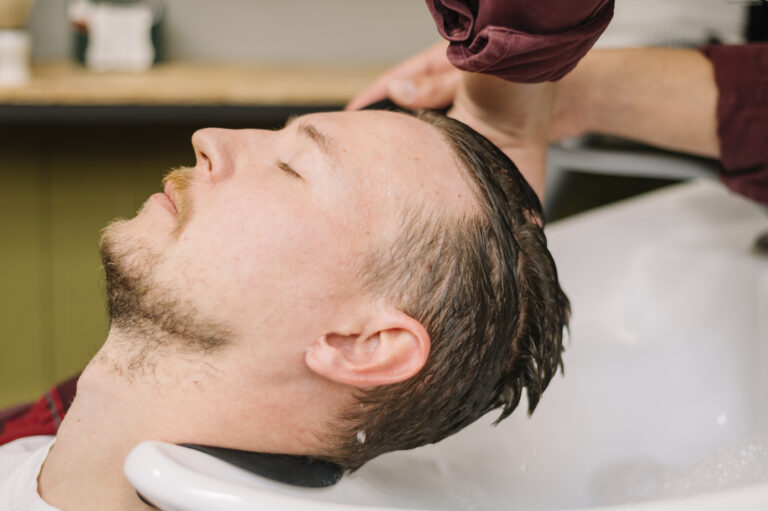 side-view-man-washing-hair-barber-shop