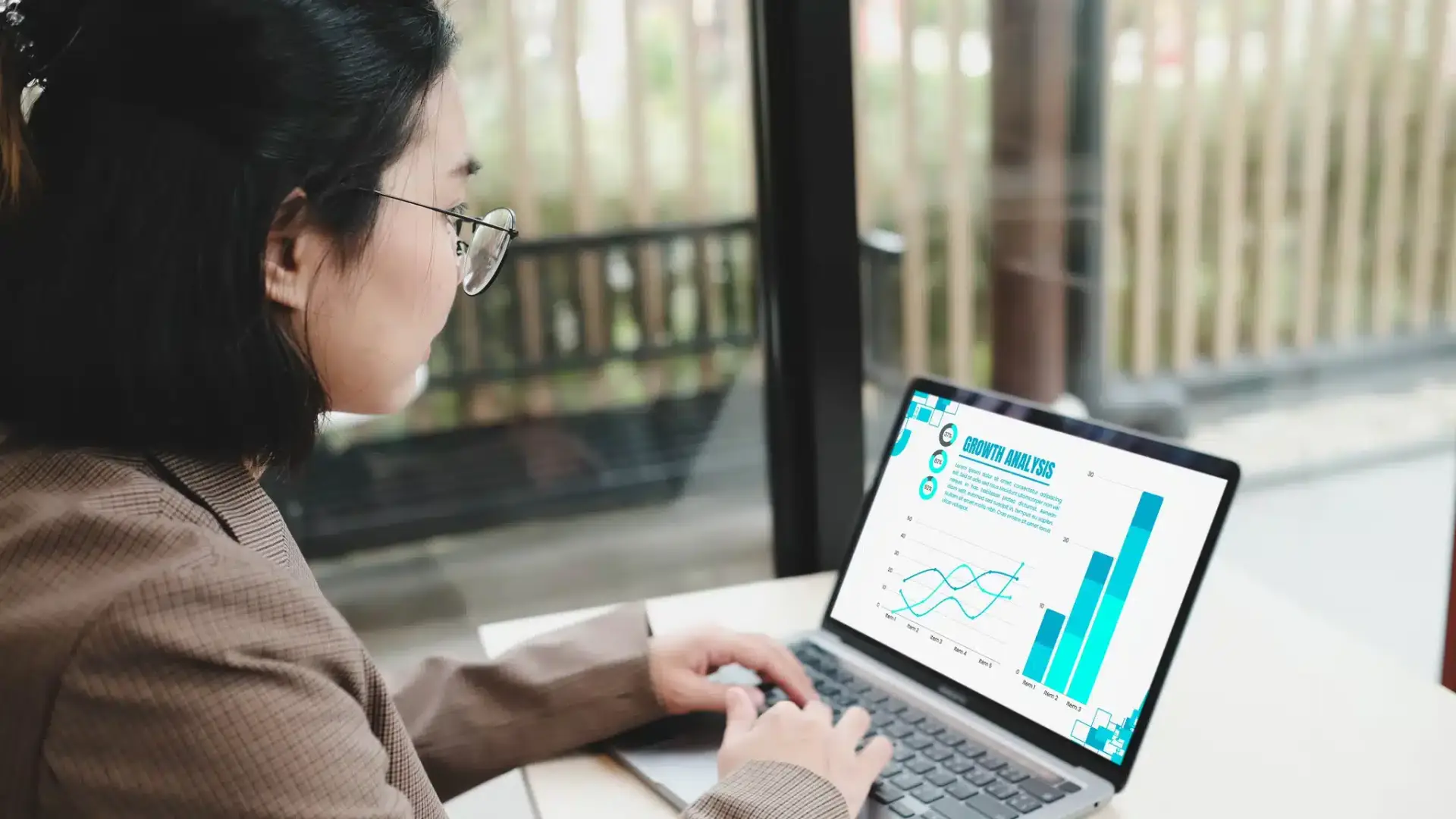 A clinic marketer reviewing website analytics and conversion charts on a laptop, representing measuring the booking funnel rather than guessing at it.