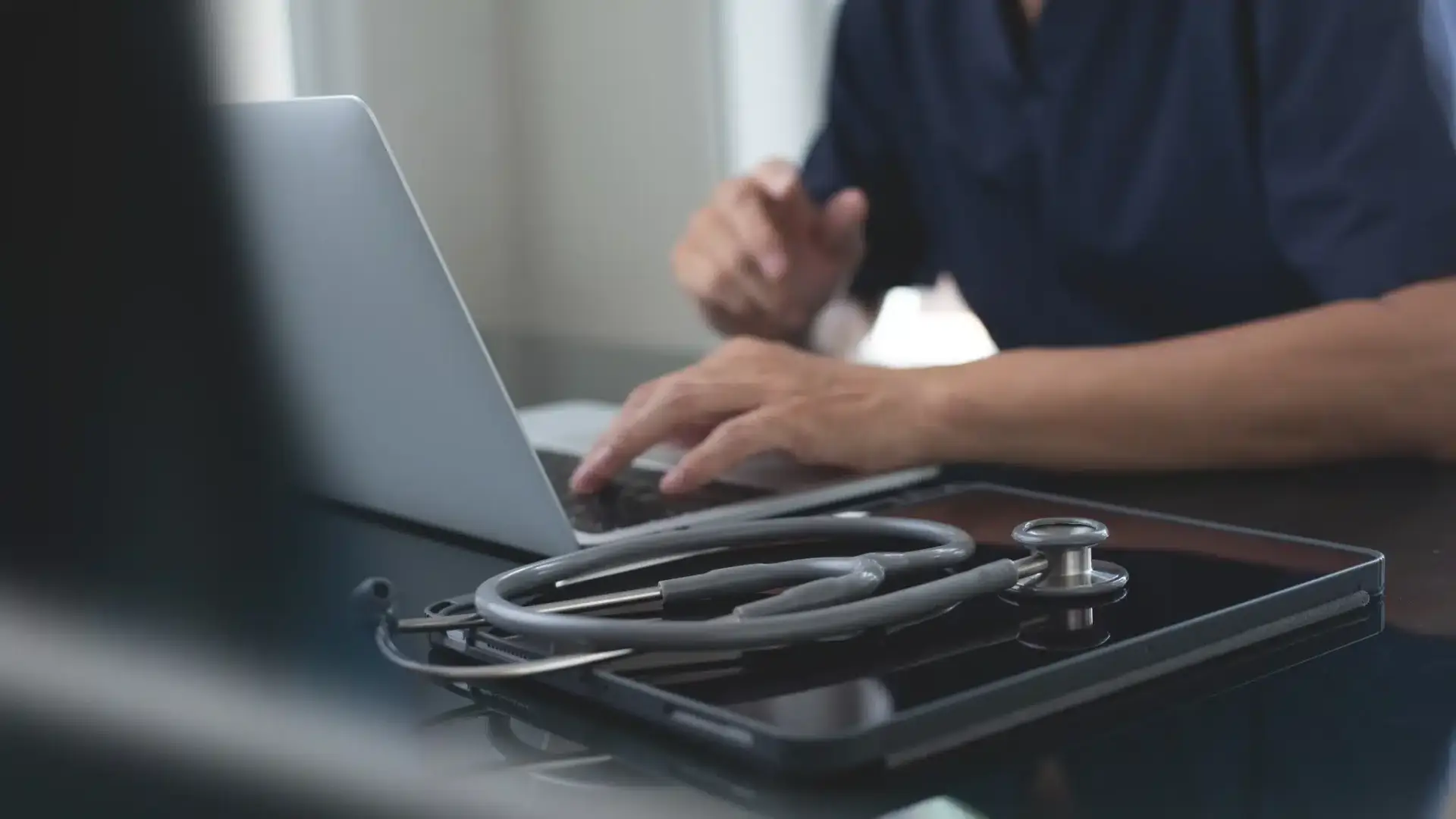 A practice owner reviewing their clinic's online reputation on a laptop, illustrating online reputation management for doctors and aesthetic practices.