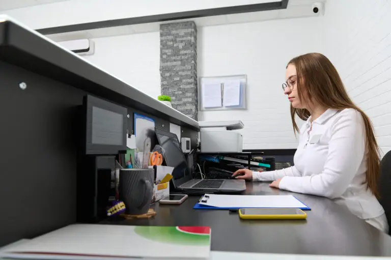 Med spa front desk receptionist booking appointments on a computer