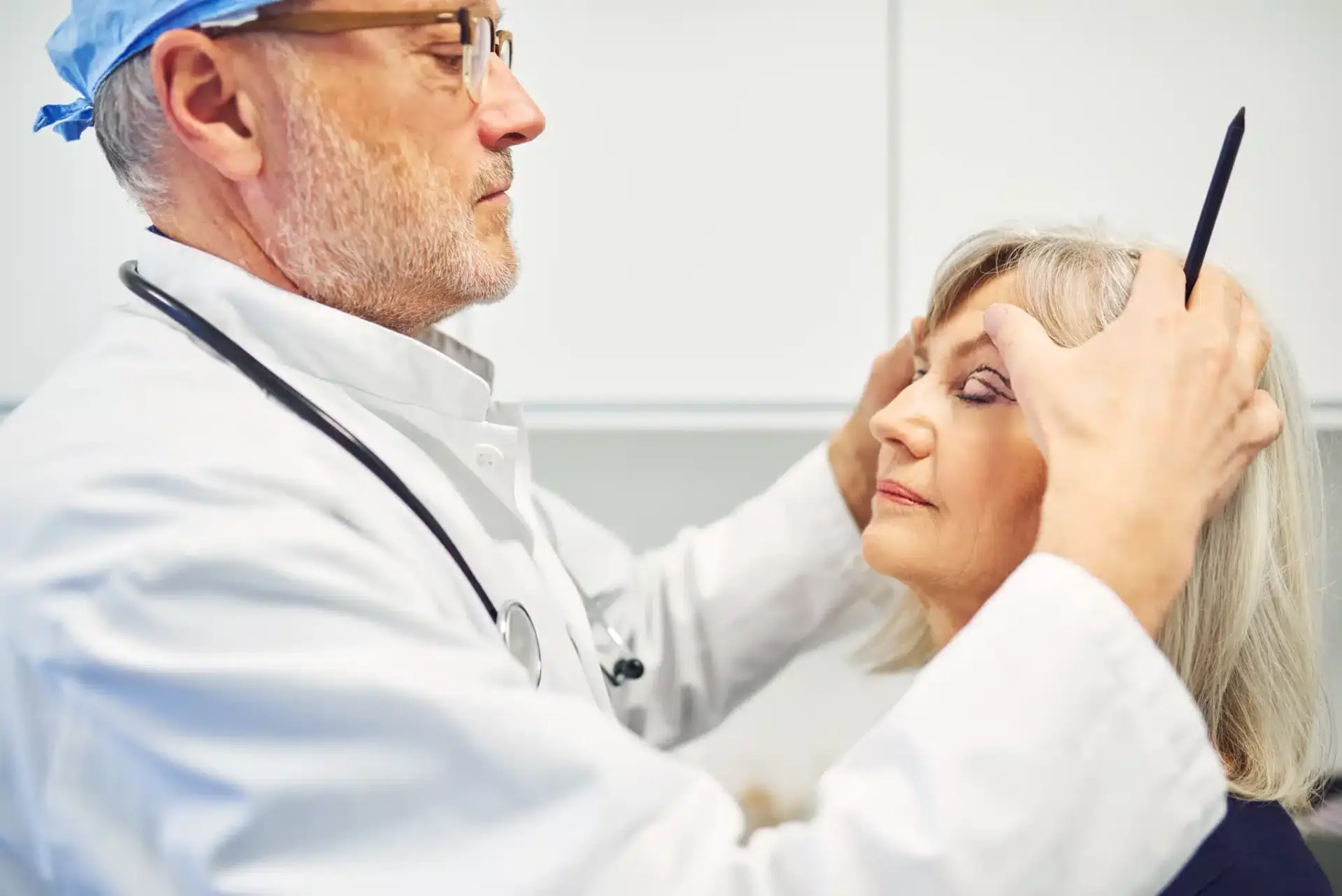 A board-certified plastic surgeon assessing a patient at a Fort Lauderdale practice