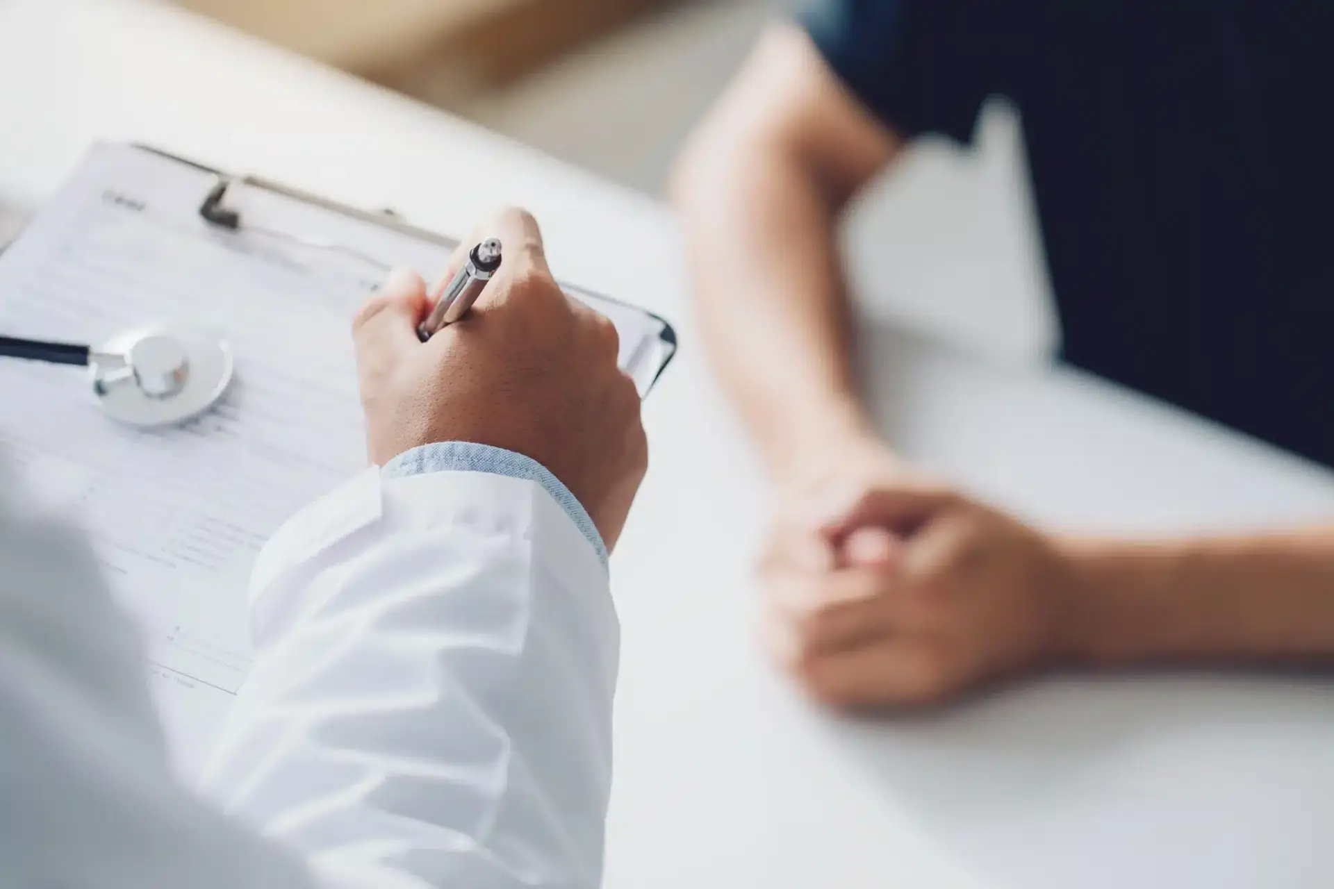 A doctor and patient reviewing information together during a consultation at a Miami plastic surgery practice