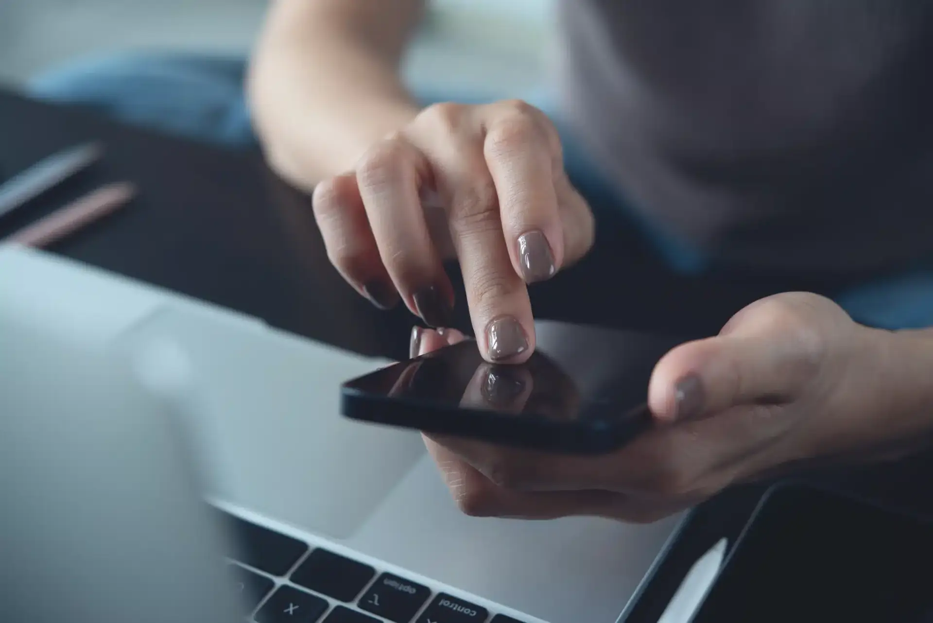 A prospective patient researching Orlando plastic surgeons on a phone