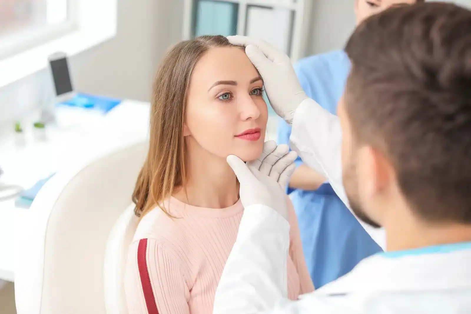 A Florida plastic surgeon examining a patient before a procedure
