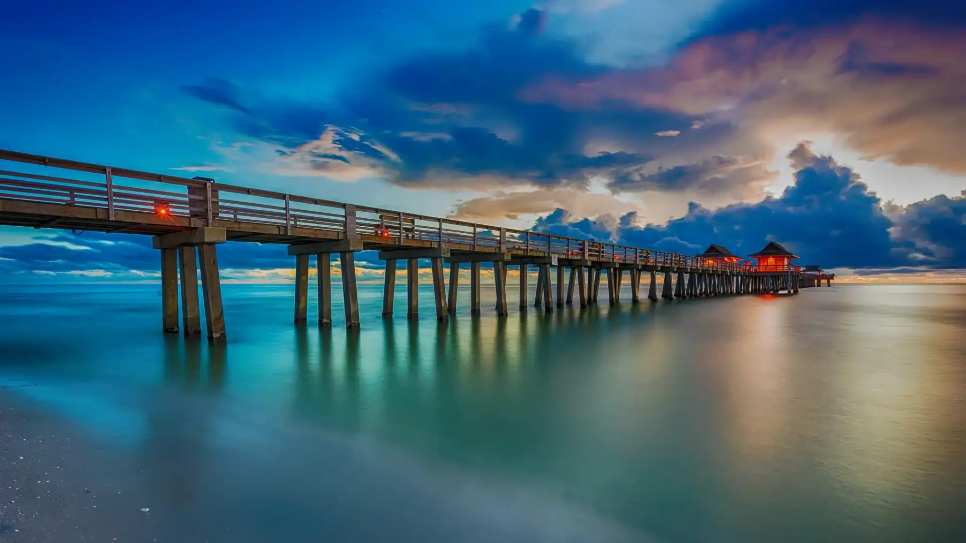 The Naples Pier and Gulf coastline in Naples, Florida, one of the wealthiest seasonal markets in the country