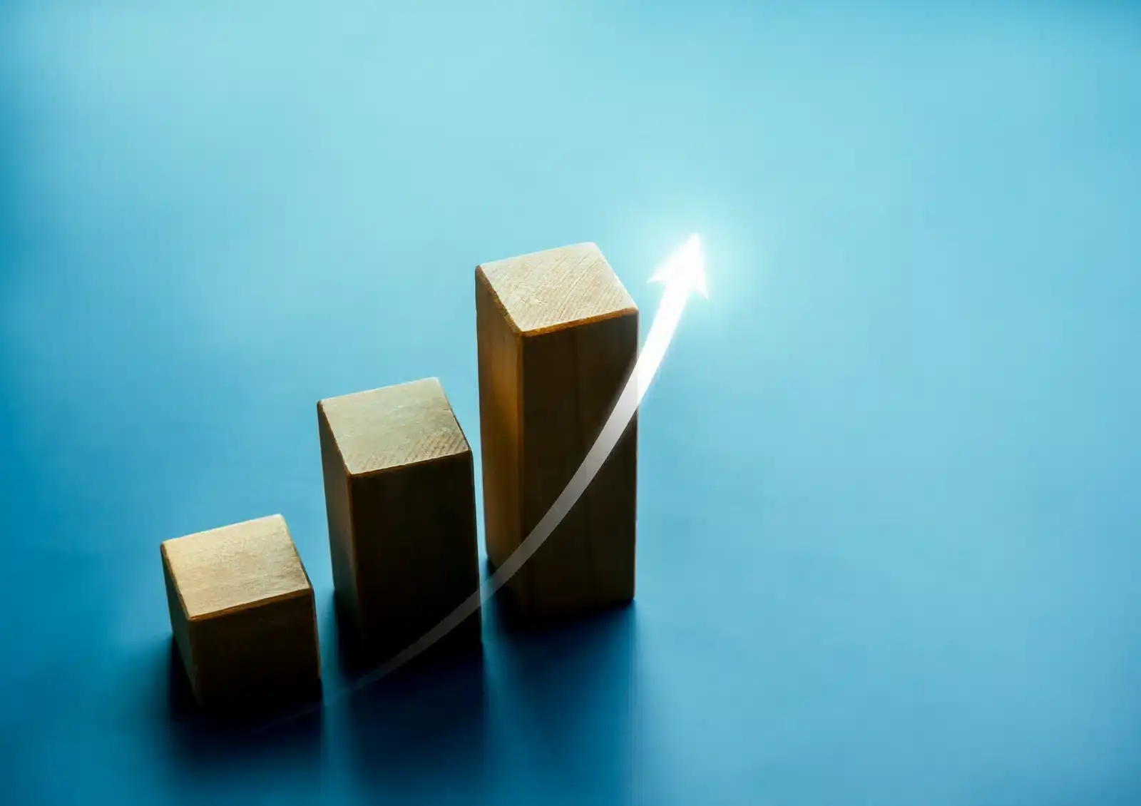 Ascending blocks with an upward arrow, illustrating how plastic surgery SEO compounds and grows over months.